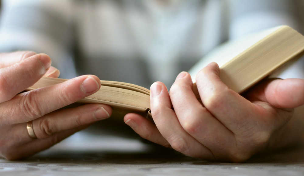 Pictures of hands holding a Bible